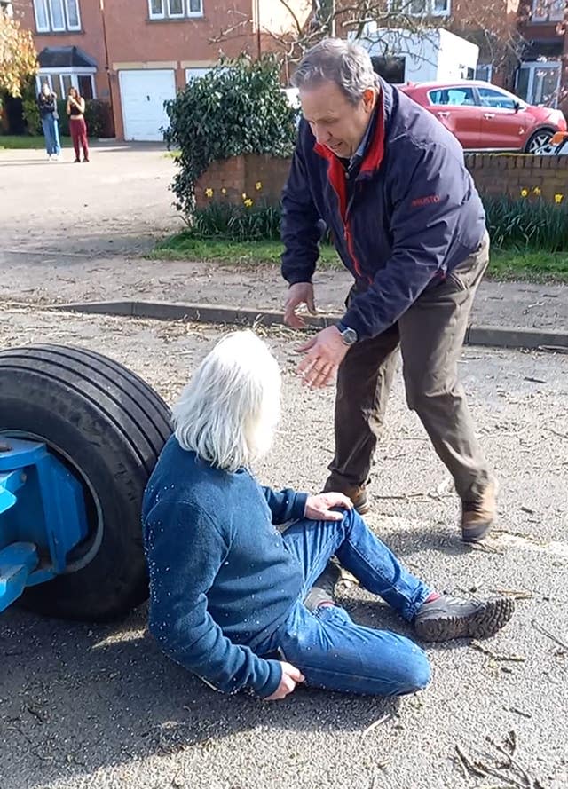 Andrew Mason in front of a tree-cutting cherry-picker as Chris Makin tries to drag him