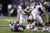 California's Damien Moore (28) is brought down on a carry by Washington's Kyler Gordon in the first half of an NCAA college football game Saturday, Sept. 25, 2021, in Seattle. (AP Photo/Elaine Thompson)