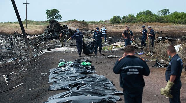 Emergency workers remove human remains from the grim site of the MH17 crash. Photo: AP.