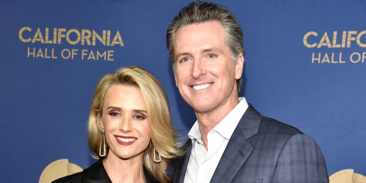 Gavin Newsom and Jennifer Siebel Newsom pose for a photo.