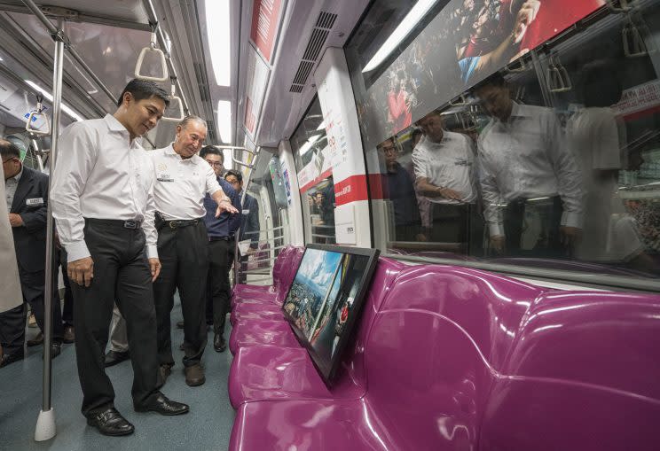 Minister for Social and Family Development Tan Chuan-Jin observes one of the displays aboard the train. (PHOTO: SMRT)