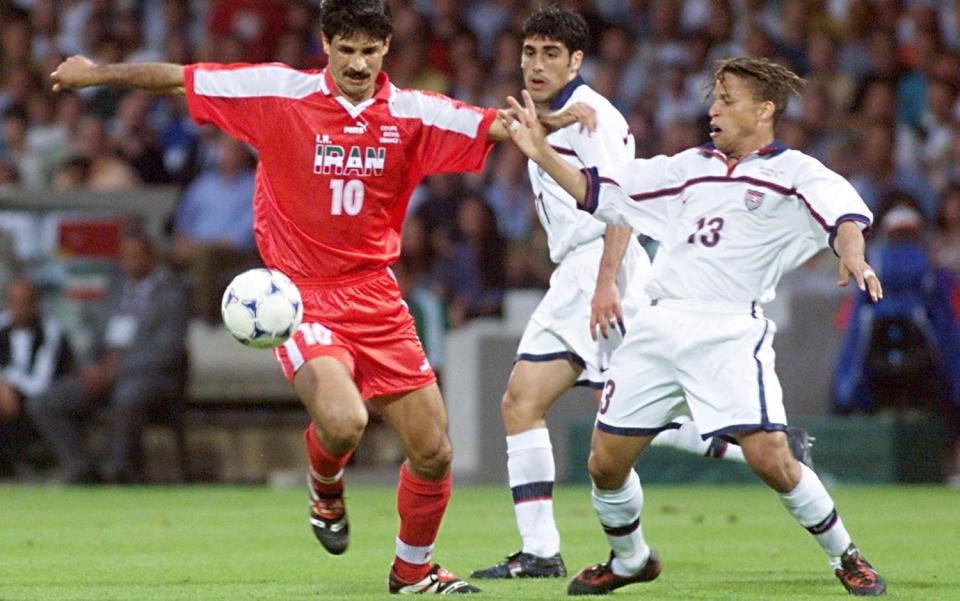 Iran forward Ali Daei (left) battles for the ball with US midfielder Cobi Jones - Gerard Malie/AFP