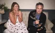 In this video grab captured on Sept. 20, 2020, courtesy of the Academy of Television Arts & Sciences and ABC Entertainment, Mark Ruffalo accepts the award for outstanding lead actor in a limited series or movie for "I Know this Much is True" during the 72nd Emmy Awards broadcast. Looking on at left is Ruffalo's wife Sunrise Coigney. (The Television Academy and ABC Entertainment via AP)