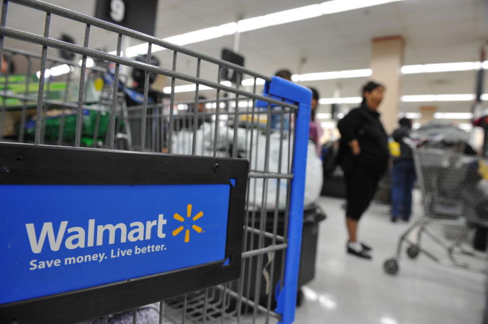 Shoppers wait in line to pay for their purchases at a Walmart store in Los Angeles, California on November 24, 2009. Walmart stores will be open on Labor Day this year. | Robyn Beck—AFP/Getty Imates