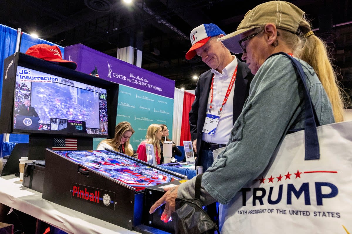 People play a January 6-themed pinball game at the Conservative Political Action Conference (CPAC) annual meeting in National Harbor, Maryland, U.S., February 22, 2024 (REUTERS)