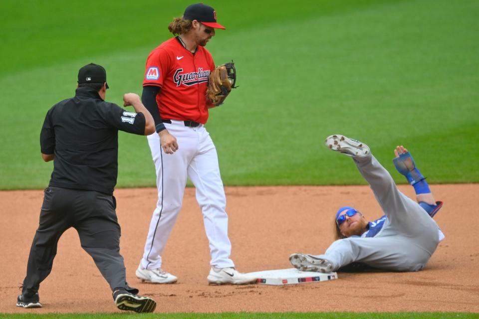 Jun 23, 2024; Cleveland, Ohio, USA; Cleveland Guardians second baseman Daniel Schneemann (10) stands beside Toronto Blue Jays designated hitter Justin Turner (2) after Turner was called out attempting to steal second base at Progressive Field. The call was later overturned and Turner was ruled safe. Mandatory Credit: David Richard-USA TODAY Sports