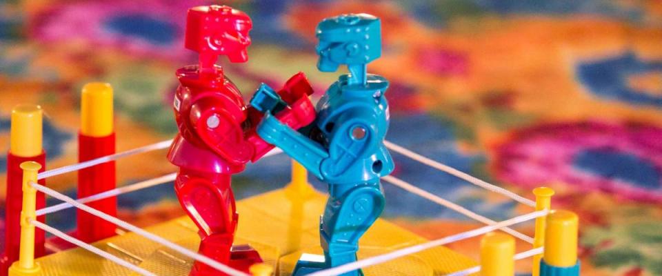 Kids brightly colored boxing robots game on multicolored table top.