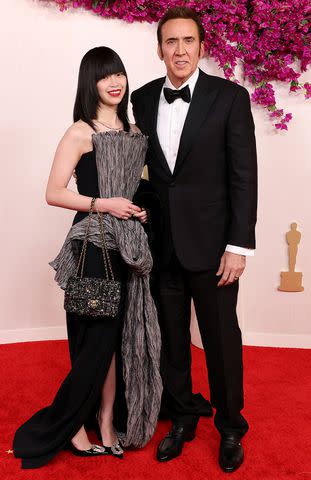 <p>John Shearer/WireImage</p> Riko Shibata and Nicolas Cage at the 2024 Oscars