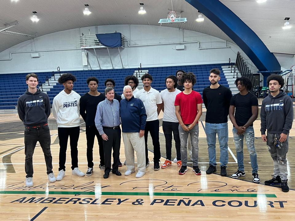 Pena and Joe Ambersley stand with current members of the PSC men's basketball team Oct. 12 after unveiling of court in their honor at PSC's Hartsell Arena.