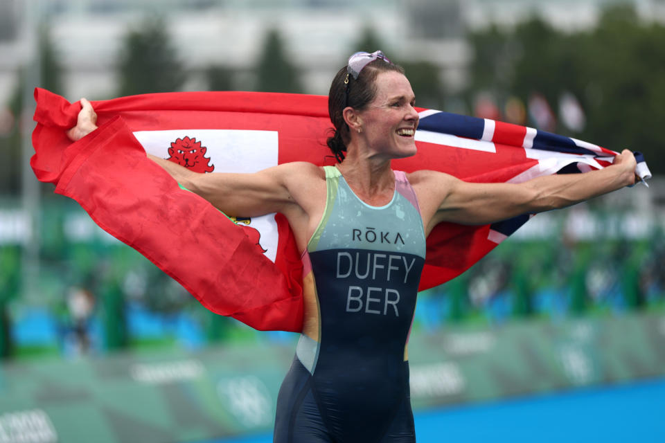 Flora Duffy of Team Bermuda celebrates win draped in Bermuda flag