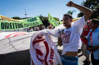 Protesters block roads and burn tires outside Brasilia stadium ahead of Confederations Cup