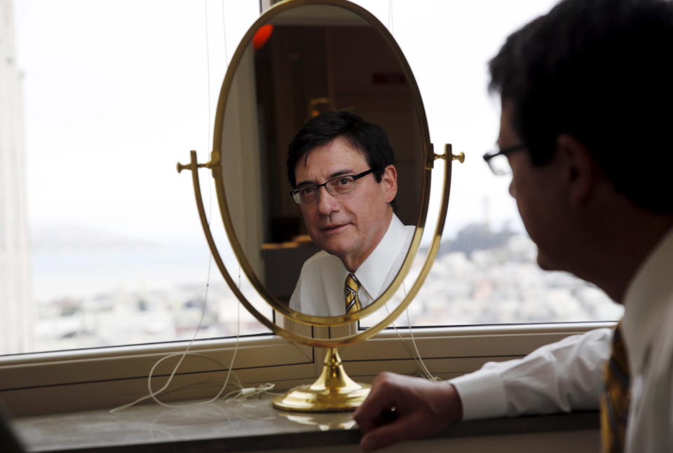 Plastic surgeon Michael Kulick looks into the mirror as he poses for a portrait at his practice in San Francisco, California July 31, 2015. Kulick now spends about 16 hours a week doing tummy tucks and other surgical procedures, double what he did in 2008. Janet Yellen made her reputation as an early spotter of the looming slump seven years ago when she highlighted some unorthodox indicators of decline in consumer spending: tummy tucks, gourmet dining and country club memberships. Now she is Federal Reserve Chair, Yellen will find a much brighter picture from her novel monitoring system as she and the Fed board mull the first U.S. interest rate hike for nine years, which could come as early as September. Picture taken July 31.   REUTERS/Robert Galbraith