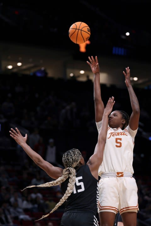 Texas forward DeYona Gaston (5) shoots as Gonzaga forward Yvonne Ejim (15) defends during the second half of a Sweet 16 college basketball game in the women’s NCAA Tournament, Friday, March 29, 2024, in Portland, Ore. (AP Photo/Howard Lao)