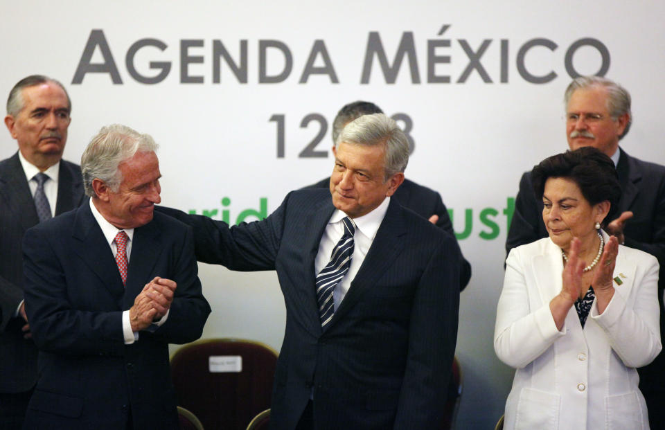 Andres Manuel Lopez Obrado, presidential candidate of the Democratic Revolution Party, PRD, center, and Mexican businessman Alejandro Marti, left front, during an event hosted by the non-governmental organization Mexico SOS, that advocates security and justice, in Mexico City, Monday April 2, 2012. The four candidates for Mexico's presidency officially launched their campaigns for the July 1 election on Friday, all of them promising change. (AP Photo/Alexandre Meneghini)