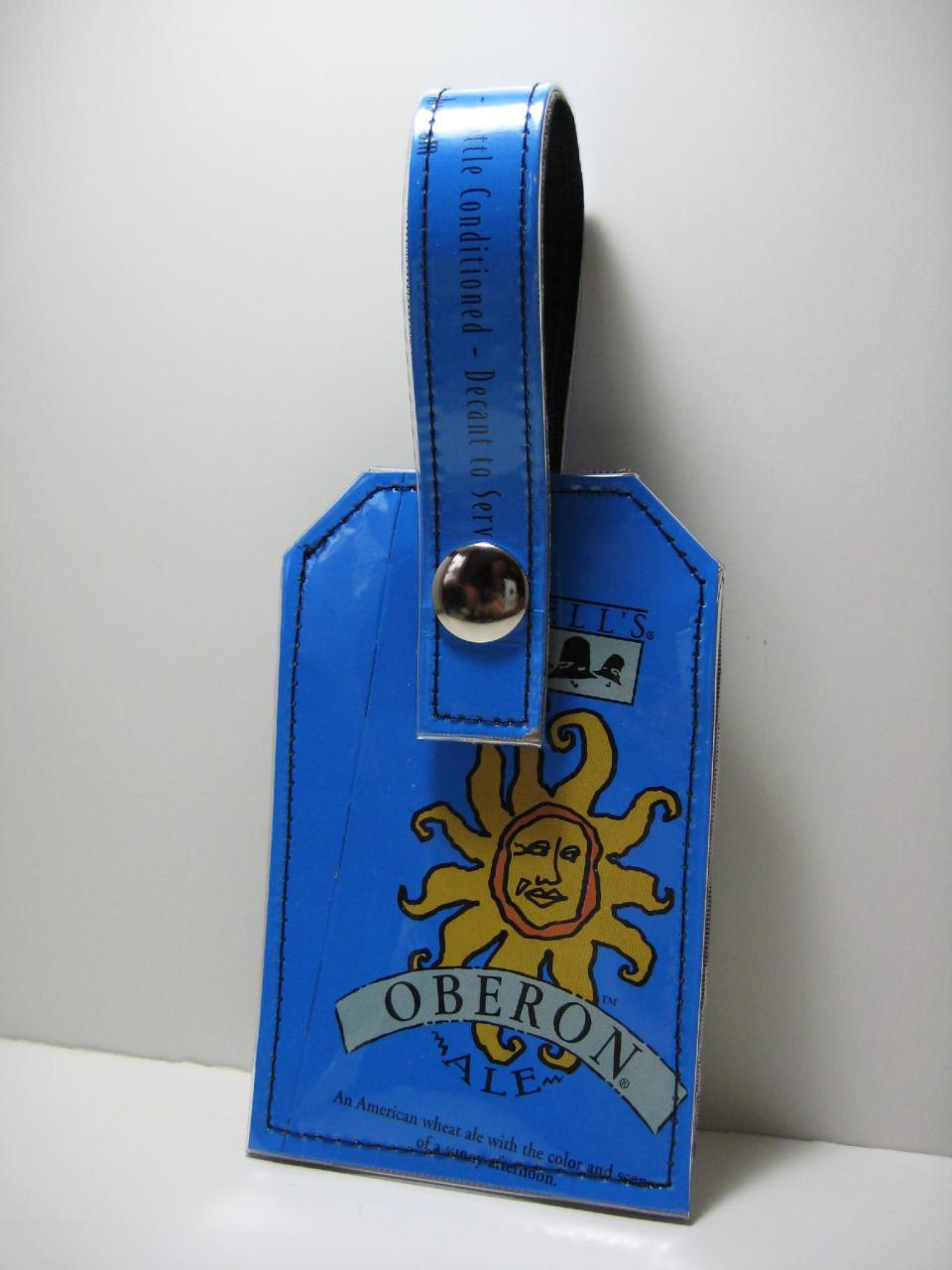 This undated publicity photo provided by Mindy's Beer Gear shows a luggage tag by Vancouver, WA – based artist Mindy Humphrey, who upcycles six pack beer packaging into accessories like wallets, luggage tags, dog collars and belts (www.etsy.com/shop/mindysdesigns). (AP Photo/Mindy's Beer Gear, Mindy Humphrey)