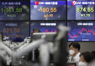 Currency traders watch computer monitors near the screens showing the foreign exchange rates at the foreign exchange dealing room in Seoul, South Korea, Monday, Sept. 28, 2020. Asian shares were mostly higher in muted trading Monday, ahead of the first U.S. presidential debate and a national holiday in China later in the week. (AP Photo/Lee Jin-man)