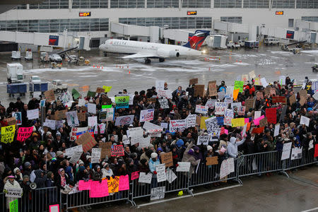 Hundreds of people rally against a travel ban signed by President Trump in an executive order, during a protest at Detroit Metropolitan airport in Romulus, Michigan. REUTERS/Rebecca Cook