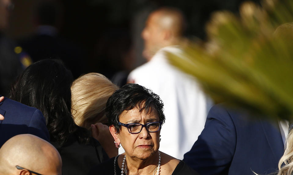 Verma Pastor, wife of former Democratic U.S. Rep. Ed Pastor, waits outside of St. Francis Xavier Catholic Church after a funeral for her husband Friday, Dec. 7, 2018, in Phoenix. Rep. Pastor was Arizona's first Hispanic member of Congress, spending 23 years in Congress before retiring in 2014. Pastor passed away last week at the age of 75. (AP Photo/Ross D. Franklin)