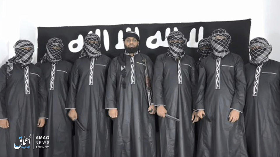 FILE - This undated file image posted by the Islamic State group's Aamaq news agency on Tuesday, April 23, 2019, purports to show Mohammed Zahran, a.k.a. Zahran Hashmi, center, the man Sri Lanka says led the Easter attack that killed over 300 people, as well as other attackers. Sri Lankan authorities have blamed the militant Muslim group National Thowfeek Jamaath for the attack. The Islamic State group released the photo Tuesday to assert its claim on the assault. (Aamaq news agency via AP, File)