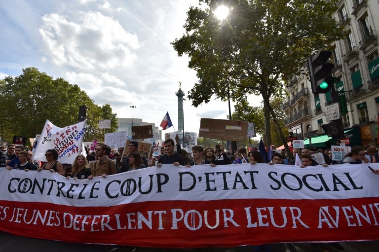 Demonstrators hold a banner reading "against the social coup d'etat" during a protest over the President Emmanuel Macron's labour reforms