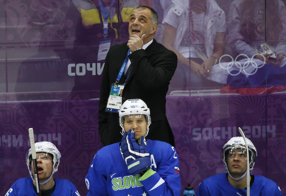 Slovenia head coach Matjaz Kopitar watches the replay of a goal by Sweden in the third period of a men's quarterfinal ice hockey game at the 2014 Winter Olympics, Wednesday, Feb. 19, 2014, in Sochi, Russia. (AP Photo/Mark Humphrey)