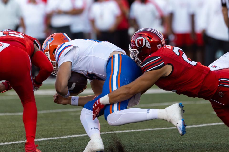 Utah Utes linebacker Karene Reid (21) tackles Florida Gators quarterback Graham Mertz (15) during the season opener at Rice-Eccles Stadium in Salt Lake City on Thursday, Aug. 31, 2023. | Megan Nielsen, Deseret News