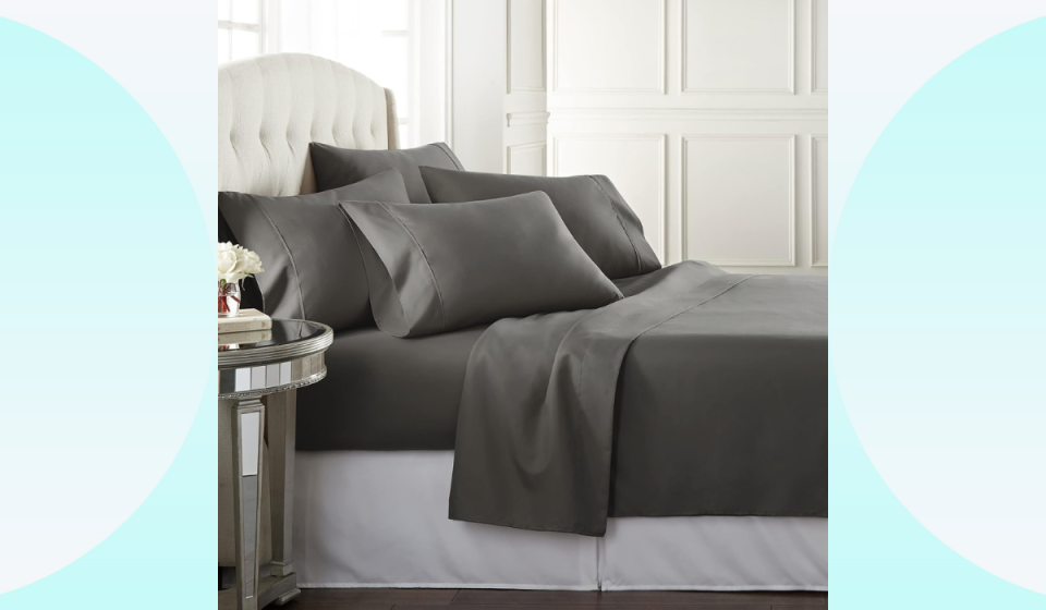 bed in bedroom with gray sheets