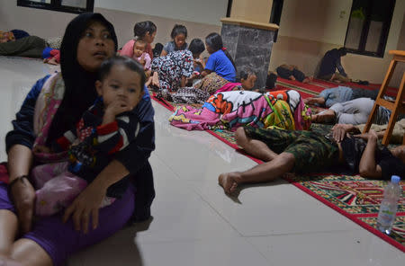 Residents sit inside a mosque as they evacuated following high waves and the eruption of Anak Krakatau volcano at Labuan district in Pandeglang regency, Banten province, Indonesia, December 22, 2018, in this photo taken by Antara Foto. Picture taken December 22, 2018. Antara Foto/Muhammad Bagus Khoirunas/ via REUTERS