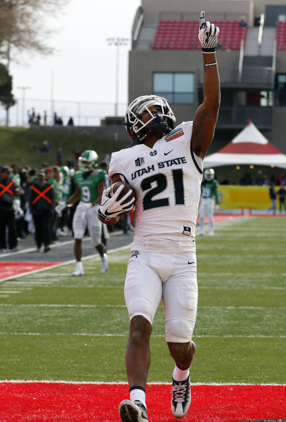Utah State wide receiver Jalen Greene celebrates after scoring a touchdown against North Texas during the first half of the New Mexico Bowl NCAA college football game in Albuquerque, N.M., Saturday, Dec. 15, 2018. (AP Photo/Andres Leighton)