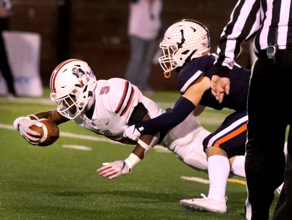 Oakland's Eric Taylor (5) dives toward the end zone for a touchdown as Beech's Caden Thieman (1) tackles him during the BlueCross Bowl Class 6A Championship game at Finley Stadium, in Chattanooga, Tenn., on Saturday, Dec. 3, 2022.  