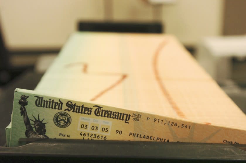 FILE - In this Feb. 11, 2005 file photo, trays of printed social security checks wait to be mailed f