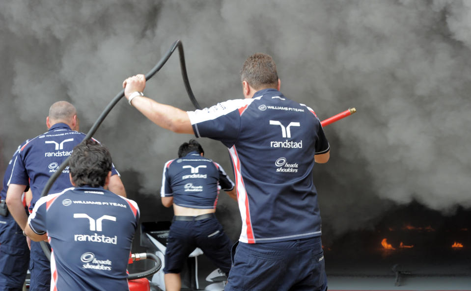 Racing team crews try to extinguish a fire in the Williams racing pit stand at the Circuit de Catalunya on May , 2012 in Montmelo on the outskirts of Barcelona after the Spanish Formula One Grand Prix. AFP PHOTO / JOSEP LAGOJOSEP LAGO/AFP/GettyImages