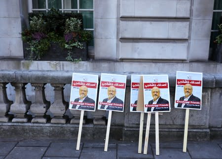 Placards can be seen outside the embassy as people protest against the killing of journalist Jamal Khashoggi in Turkey outside the Saudi Arabian Embassy in London