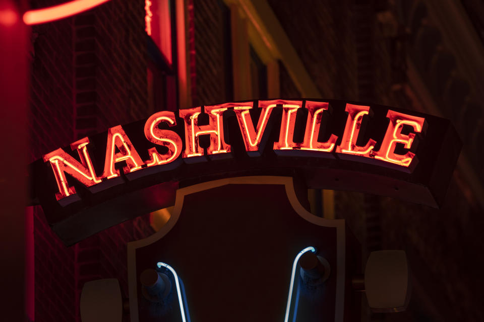 Neon sign reading 'NASHVILLE' at night, likely indicating the city's vibrant scene