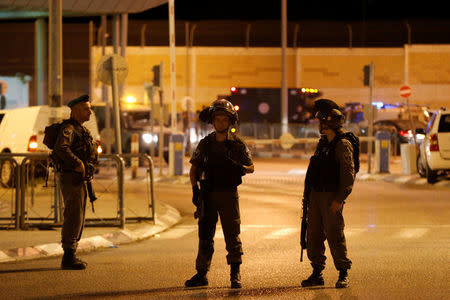 Israeli border police officers stand guard near the scene of a stabbing attack at Israeli Qalandia checkpoint near the West Bank city of Ramallah September 30, 2016. REUTERS/Ammar Awad