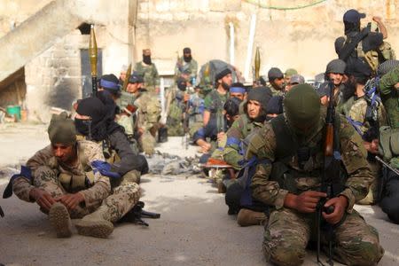 Members of al Qaeda's Nusra Front prepare themselves before moving towards their positions during an offensive to take control of the northwestern city of Ariha from forces loyal to Syria's President Bashar al-Assad, in Idlib province May 28, 2015. REUTERS/Ammar Abdullah