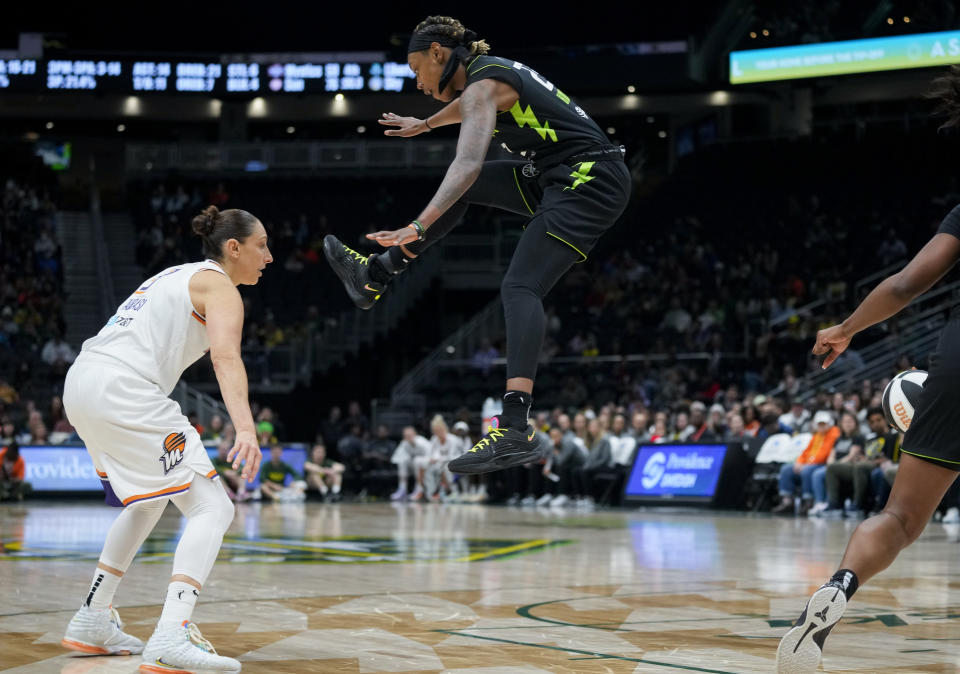 Phoenix Mercury guard Diana Taurasi, left, passes the ball as Seattle Storm guard Jordan Horston jumps to defend during the second half of a WNBA basketball game Tuesday, June 4, 2024, in Seattle. The Storm won 80-62. (AP Photo/Lindsey Wasson)