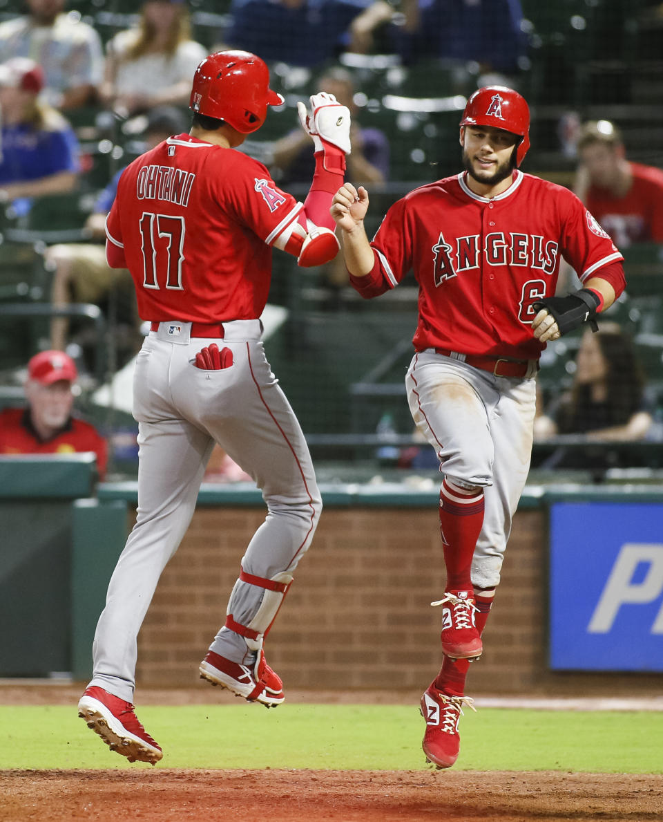 Los Angeles Angels' Shohei Ohtani (17) jumps in the air at home plate with David Fletcher (6) after hitting a two-run home run against the Texas Rangers during the eighth inning of a baseball game Wednesday, Sept. 5, 2018, in Arlington, Texas. (AP Photo/Ray Carlin)