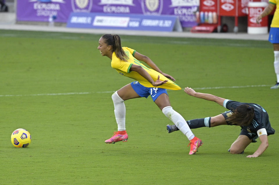 Brazil midfielder Adriana, left, is grabbed by Argentina midfielder Vanesa Santana during the second half of a SheBelieves Cup women's soccer match, Thursday, Feb. 18, 2021, in Orlando, Fla. (AP Photo/Phelan M. Ebenhack)