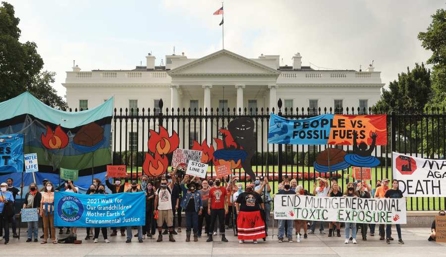 Demonstrators prepare to be arrested during a rally outside the White House as part of the ‘Climate Chaos Is Happening Now’ protest on Oct. 13, 2021 in Washington, D.C. Organized by the Indigenous Environmental Network, the Sunrise Movement and other groups, activists marched to the White House for the third of five planned days to demand that U.S. President Joe Biden stop approving fossil fuel projects and declare a climate emergency ahead of the United Nations climate summit in November. (Photo by Chip Somodevilla/Getty Images)