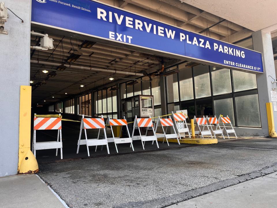 Barricades prevent access to the Riverview Plaza parking garage in Downtown Peoria on July 15. Corrosion and crumbling concrete have made the garage unsafe to access.