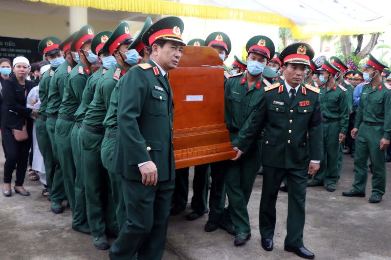 Vietnam's Chief of General staff Phan Van Giang and military officers carry the coffin of General Nguyen Van Man who died of a landslide on a rescue mission at a hydropower plant, during his funeral ceremony in Thua Thien Hue province