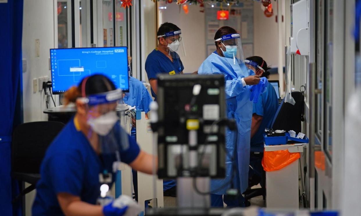 <span>Medical staff wearing PPE on a ward for Covid patients at King's College Hospital, London, in December 2021.</span><span>Photograph: PA Images/Alamy</span>