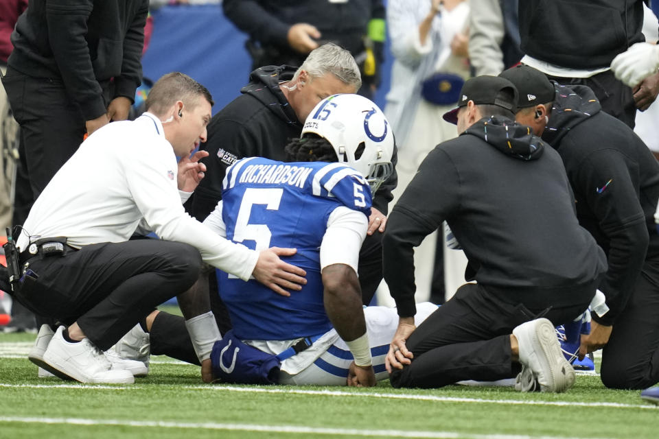Indianapolis Colts quarterback Anthony Richardson (5) is checked out by medical staff on the field after being injured during the first half of an NFL football game against the Tennessee Titans, Sunday, Oct. 8, 2023, in Indianapolis. (AP Photo/Michael Conroy)