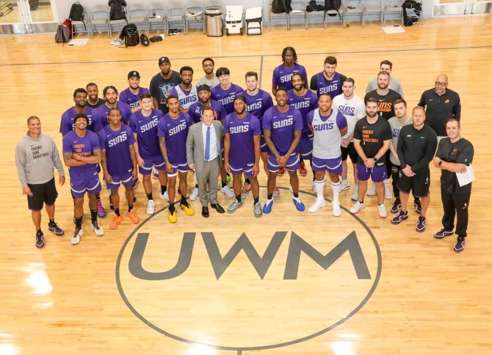 Phoenix Suns team owner Mat Ishbia takes a picture with the team's players and coaches Oct. 9, 2023 as they practiced at a gym on United Wholesale Mortgage's campus in Pontiac, Michi.