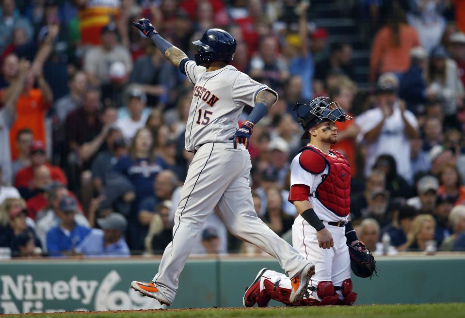 Houston Astros' Martin Maldonado (15) celebrates his solo home run behind Boston Red Sox's Christian Vazquez during the fourth inning of a baseball game in Boston, Saturday, Sept. 8, 2018. (AP Photo/Michael Dwyer)