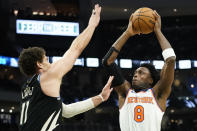New York Knicks' OG Anunoby (8) drives to the basket against Milwaukee Bucks' Brook Lopez (11) during the first half of an NBA basketball game Sunday, April 7, 2024, in Milwaukee. (AP Photo/Aaron Gash)