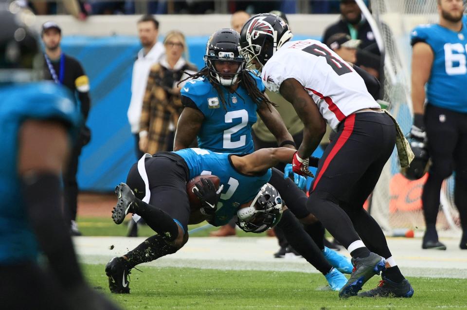Jaguars cornerback Tyson Campbell (32) picks up his first career interception as Atlanta Falcons tight end Kyle Pitts (8) tries to make the stop.