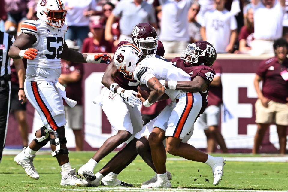 Sep 23, 2023; College Station, Texas, USA; Texas A&M Aggies defensive back Bobby Taylor (9) tackles Auburn Tigers quarterback Robby Ashford (9) during the third quarter at Kyle Field. Mandatory Credit: Maria Lysaker-USA TODAY Sports