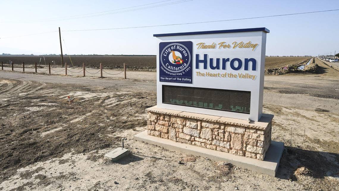 A sign on the edge of the town of Huron sits near an empty field on Thursday, Sept. 15, 2022. Many fields around the southern San Joaquin Valley have been left fallow as the drought continues, drying up work for families in the process.